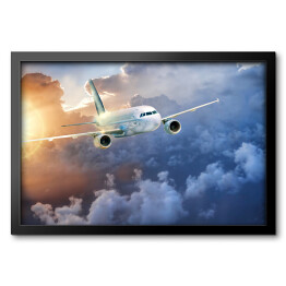 Obraz w ramie Samolot wśród chmur w blasku słońca