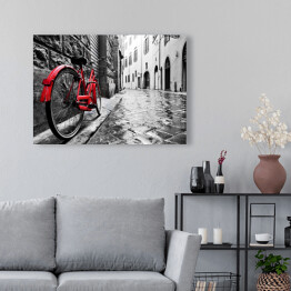 Obraz na płótnie Retro czerwony rower na chodniku w starym miasteczku