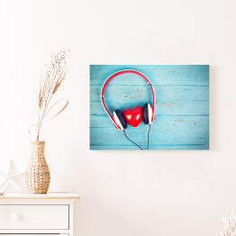 Obraz na płótnie Serce wsłuchujące się w muzykę na tle z niebieskiego drewna