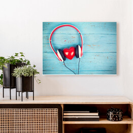 Obraz na płótnie Serce wsłuchujące się w muzykę na tle z niebieskiego drewna