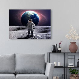 Obraz na płótnie Astronauta na spacerze kosmicznym na księżycu na tle planety