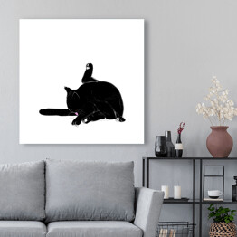 Obraz na płótnie Czarny kot myjący ogon
